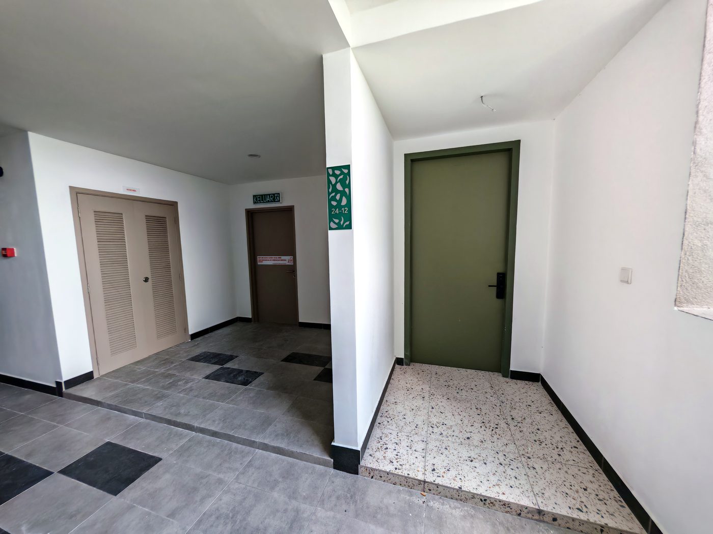 Apartment unit front entrance with leaf-theme house numbering at Dedaun Residensi